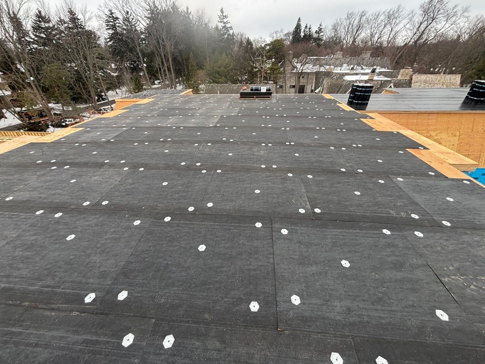 Flat roof membrane mid-install in winter